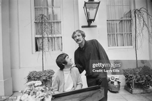 American songwriter, composer and singer Jimmy Webb, playing a piano with Irish actor and singer Richard Harris , UK, 16th October 1968.