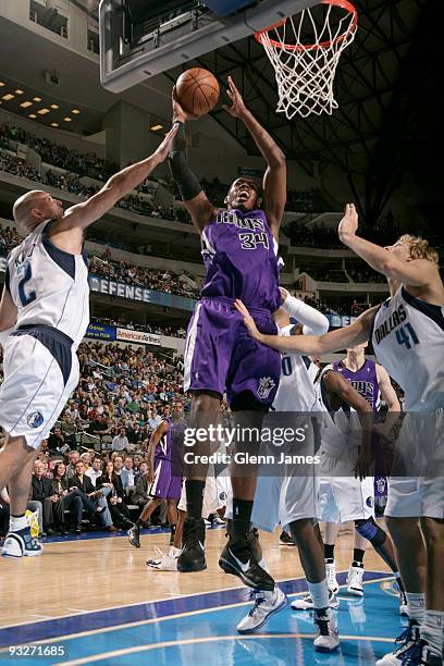 Jason Thompson of the Sacramento Kings goes up for the layup against Jason Kidd of the Dallas Mavericks during a game at the American Airlines Center...