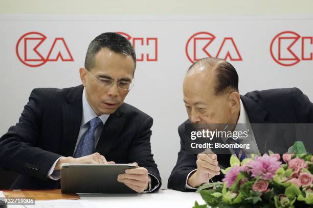 Victor Li, deputy chairman and co-managing director of CK Hutchison Holdings Ltd., left, speaks with Li Ka-shing, chairman of CK Hutchison Holdings...