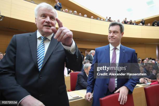 Markus Soeder of the Bavarian Christian Democrats arrives with German Interior Minister Horst Seehofer at the Bavarian state parliament on March 16,...