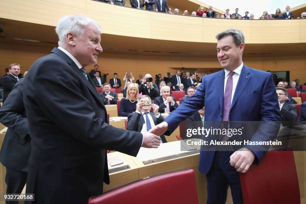 Markus Soeder of the Bavarian Christian Democrats arrives with German Interior Minister Horst Seehofer at the Bavarian state parliament on March 16,...