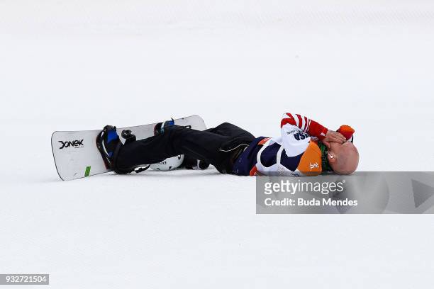 Mike Minor of the United States celebrates after his run which wins him the Gold medal during the Men's snowboard Slalom SB-UL during day seven of...