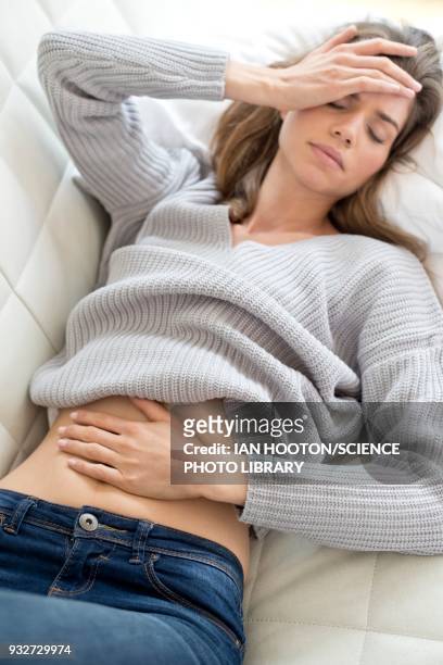 woman with hand on stomach and head - pms stock pictures, royalty-free photos & images