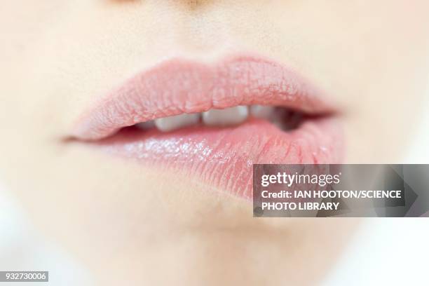 woman biting lip - female biting lips stockfoto's en -beelden