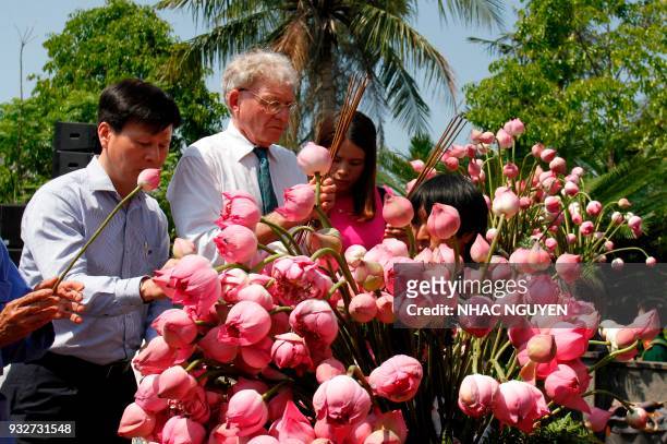 Vietnamese and US representatives pay their respects at a war memorial dedicated to the victims of the My Lai massacre at the village of Son My in...