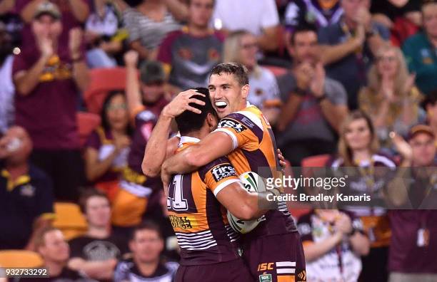 Alex Glenn of the Broncos celebrates with Corey Oates after scoring a try during the round two NRL match between the Brisbane Broncos and the North...