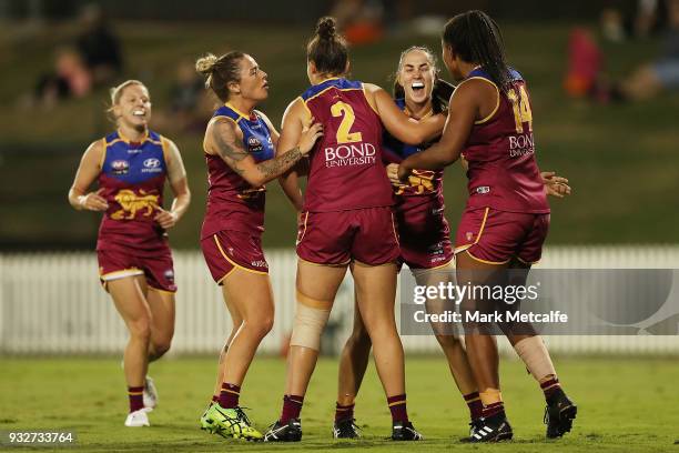 Sharni Webb of the Lions celebrates with team mates after kicking a goal during the round seven AFLW match between the Greater Western Sydney Giants...