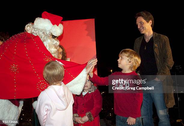 Richard Marx watches as Santa Claus greets patients from St. Jude Children's Research Hospital at the annual Elvis Presley lighting celebration at...