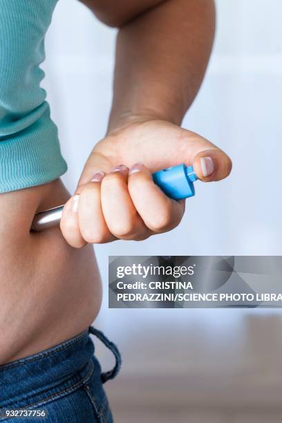 woman injecting herself in her side - adrenaline injection stock pictures, royalty-free photos & images