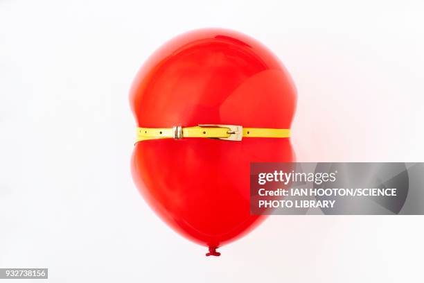 red balloon, conceptual image of bloated stomach - yellow belt stock pictures, royalty-free photos & images
