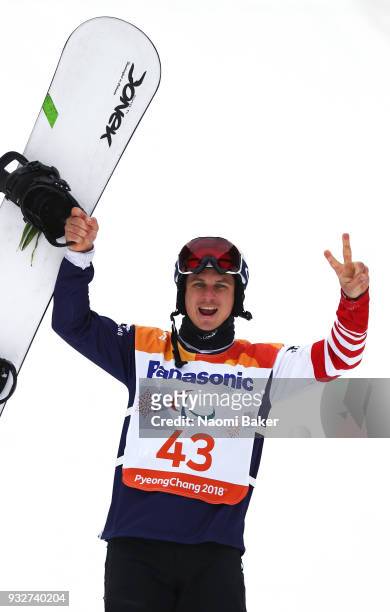 Silver Medalist Evan Strong of the United States celebrates during the victory ceremony for the Men's Snowboard Banked Slalom SB-LL2 during day seven...