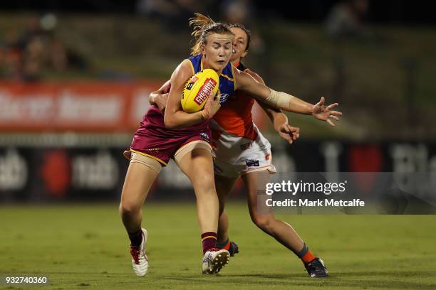 Shannon Campbell of the Lions is tackled by Renee Forth of the Giants during the round seven AFLW match between the Greater Western Sydney Giants and...