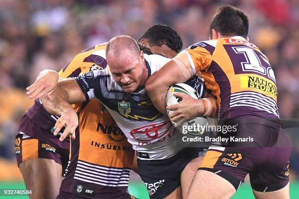 Matthew Scott of the Cowboys takes on the defence during the round two NRL match between the Brisbane Broncos and the North Queensland Cowboys at...