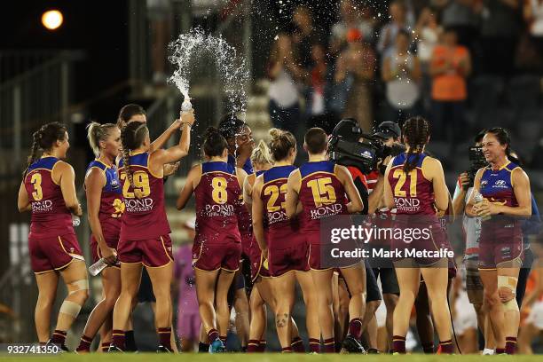 Lions players celebrate victory during the round seven AFLW match between the Greater Western Sydney Giants and the Brisbane Lions at Blacktown...