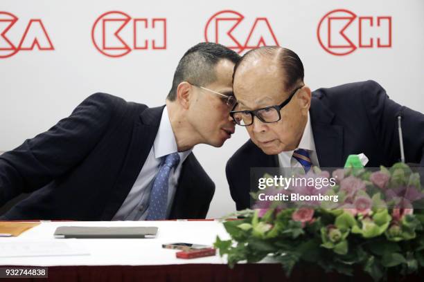 Victor Li, deputy chairman and co-managing director of CK Hutchison Holdings Ltd., left, speaks with Li Ka-shing, chairman of CK Hutchison Holdings...