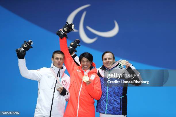 Gold medallist Gurimu Narita of Japan , Silver medallist Evan Strong of USA and Bronze medallist Matti Suur-Hamari of Finland celebrate during the...