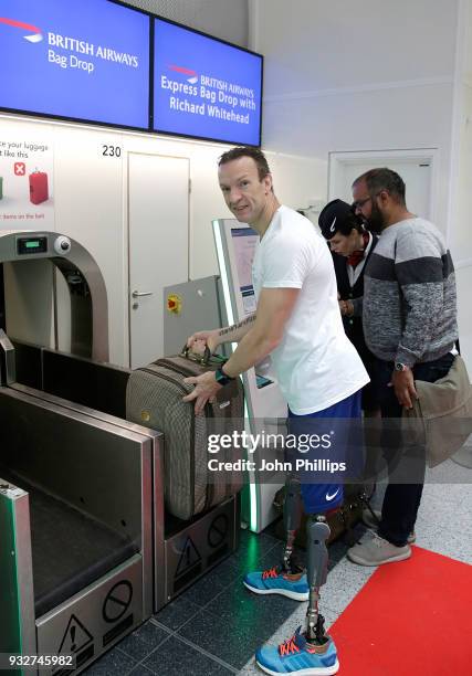 British athlete Richard Whitehead helps British Airways customers with their bag drop at Gatwick Airport, to raise money for Sport Relief on March...