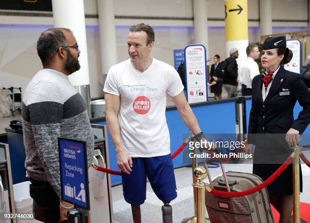 British athlete Richard Whitehead helps British Airways customers with their bag drop at Gatwick Airport, to raise money for Sport Relief on March...