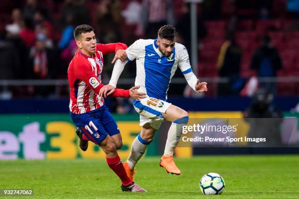 Diego Rico Salguero of CD Leganes battles for the ball with Angel Correa of Atletico de Madrid during the La Liga 2017-18 match between Atletico de...