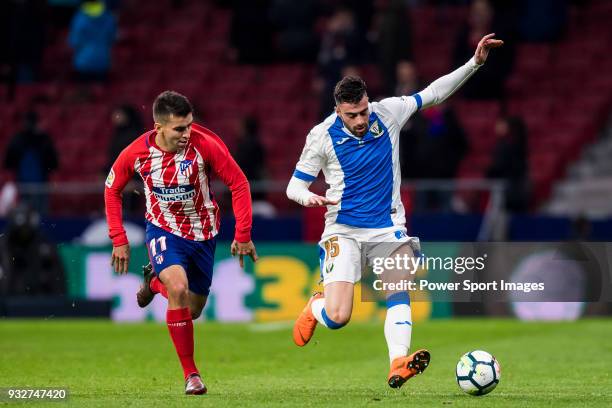 Diego Rico Salguero of CD Leganes battles for the ball with Angel Correa of Atletico de Madrid during the La Liga 2017-18 match between Atletico de...