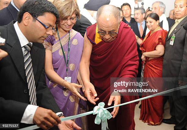 Tibetan exiled spiritual leader the Dalai Lama unties a ribbon to inaugurate a new unit at Max Heart and Vascular Institute hospital in New Delhi on...