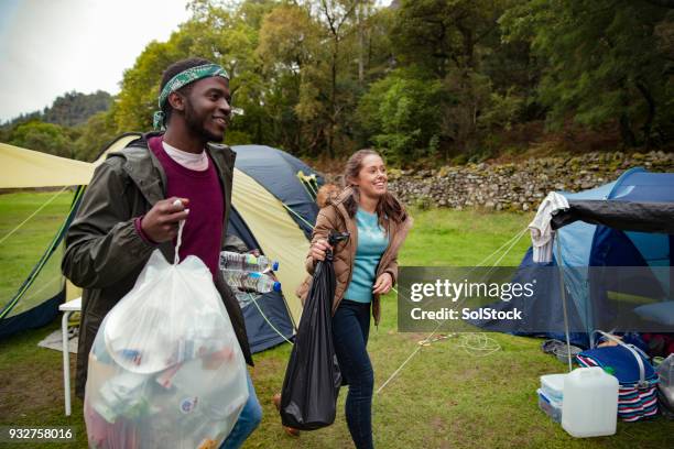 clearing up the camping rubbish - bin bag stock pictures, royalty-free photos & images