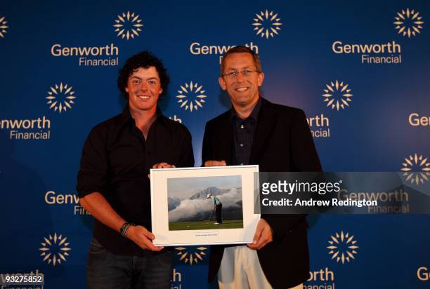 Rory McIlroy of Northern Ireland receives his Stroke Average Award from Peter Barrett, MD of Genworth, at the Genworth Financial Statistics Awards...