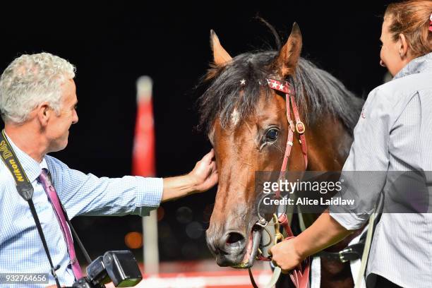 Part owner Brett Holburt with Cliff's Edge after winning the Hacer Group Alister Clark Stakes at Moonee Valley Racecourse on March 16, 2018 in Moonee...