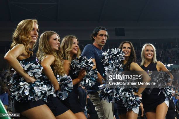 Andy Lee poses with cheerleaders during game one of the NBL Grand Final series between Melbourne United and the Adelaide 36ers at Hisense Arena on...