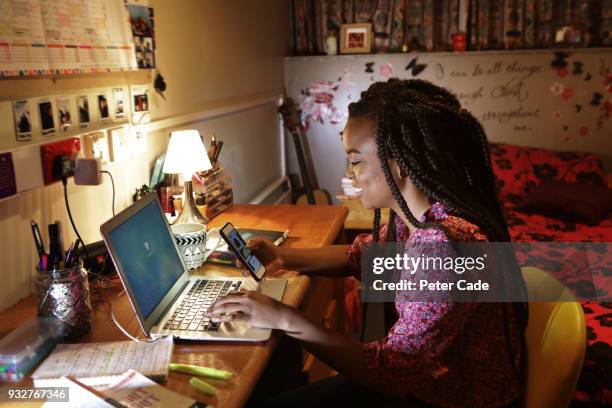 student sat at desk in bedroom looking at phone - sattel bildbanksfoton och bilder