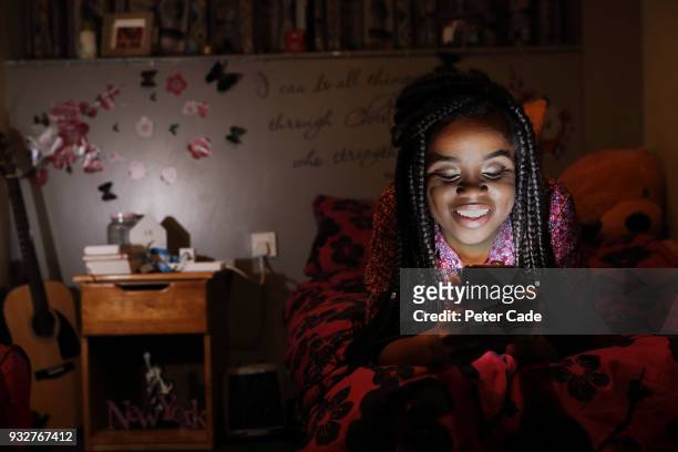 student in room an phone at night - braiding hair stock pictures, royalty-free photos & images