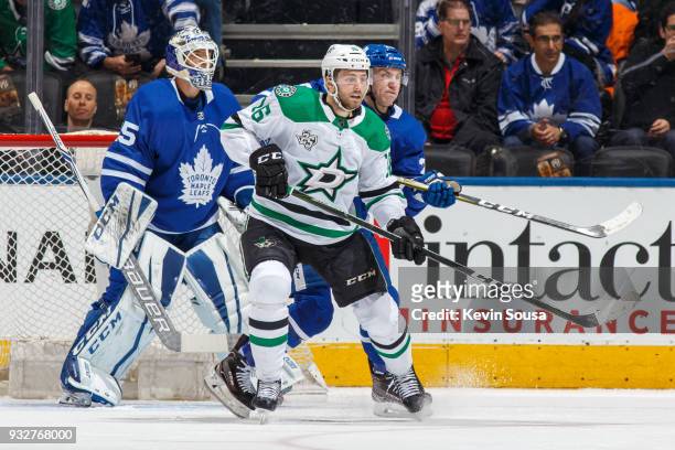 Travis Dermott of the Toronto Maple Leafs battles for position against Jason Dickinson of the Dallas Stars in front of James van Riemsdyk during the...