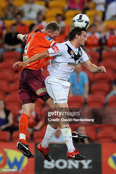 Craig Moore of the Roar and Nick Ward of the Victory compete for the ball during the round 15 A-League match between the Brisbane Roar and the...