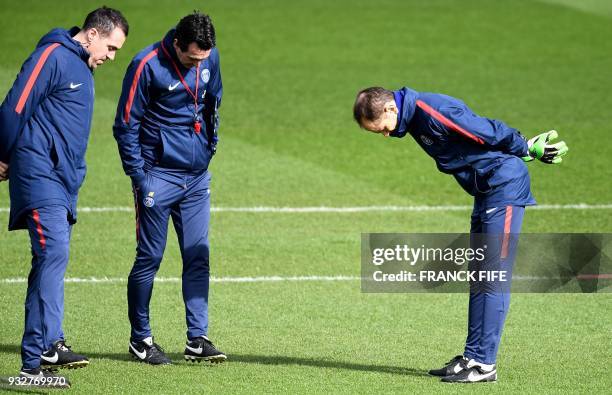 Paris Saint-Germain's Spanish assistant coach Juan Carlos Carcedo, headcoach Unai Emery and goalkeeping coach Javi Garcia look at the pitch during a...