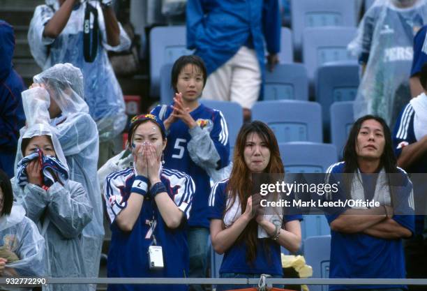 June 2002 Rifu - FIFA World Cup - Japan v Turkey - despondent Japanese supporters standing in the rain
