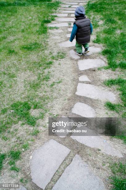 a child in blue walking on the stone paths - stepping stone top view stock pictures, royalty-free photos & images