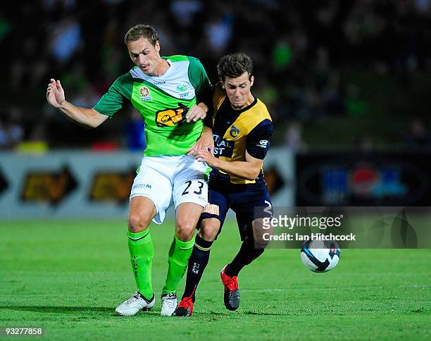 Roystyn Griffiths of the Fury contests the ball with Nicky Travis of the Mariners during the round 15 A-League match between North Queensland Fury...