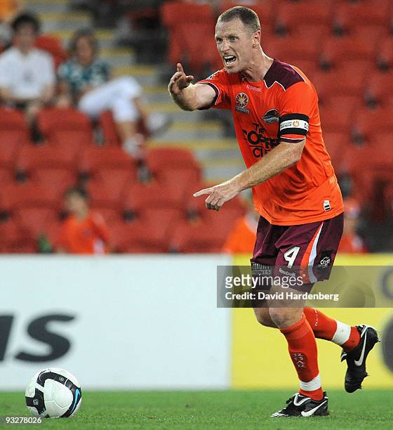 Captain Craig Moore of the Roar talks to his players during the round 15 A-League match between the Brisbane Roar and the Melbourne Victory at...