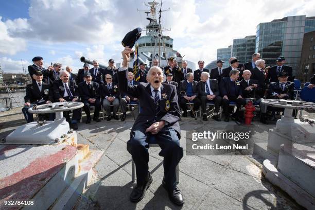 Former Ordance Artificer John Harrison, aged 103, poses for photographs with a group of other veterans who also served aboard the HMS Belfast during...