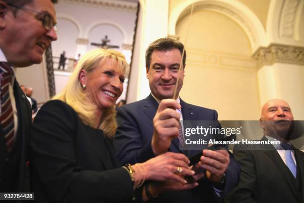 Markus Soeder of the Bavarian Christian Democrats and the new Governor of Bavaria smiles with his iwfe Karin Soeder at the Bavarian state parliament...