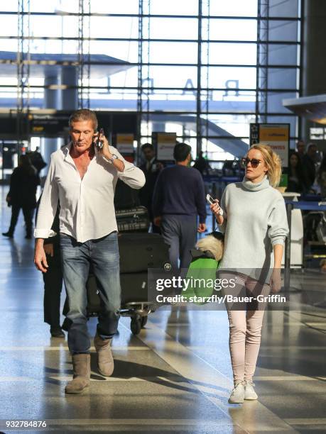 David Hasselhoff and Hayley Roberts are seen at Los Angeles International Airport on March 15, 2018 in Los Angeles, California.