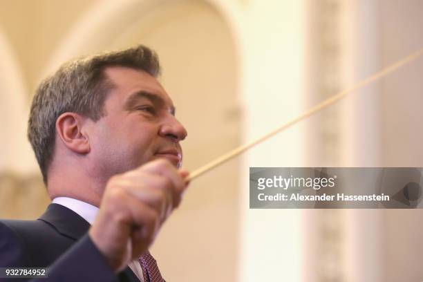 Markus Soeder of the Bavarian Christian Democrats and the new Governor of Bavaria conducts a bavarian brass band at the Bavarian state parliament on...
