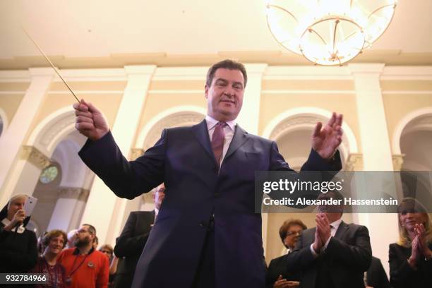 Markus Soeder of the Bavarian Christian Democrats and the new Governor of Bavaria conducts a bavarian brass band at the Bavarian state parliament on...