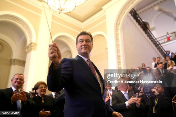 Markus Soeder of the Bavarian Christian Democrats and the new Governor of Bavaria conducts a bavarian brass band at the Bavarian state parliament on...