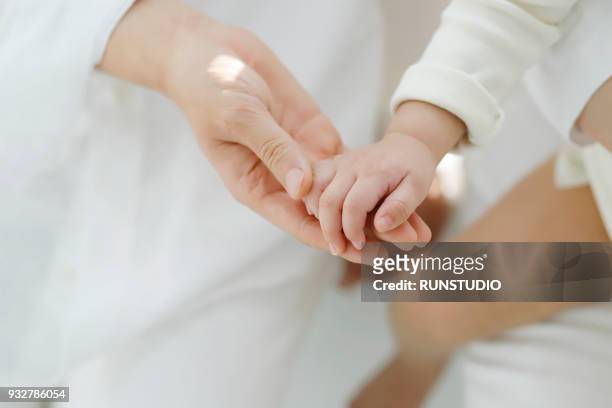 hands of baby and mother - baby hands ストックフォトと画像