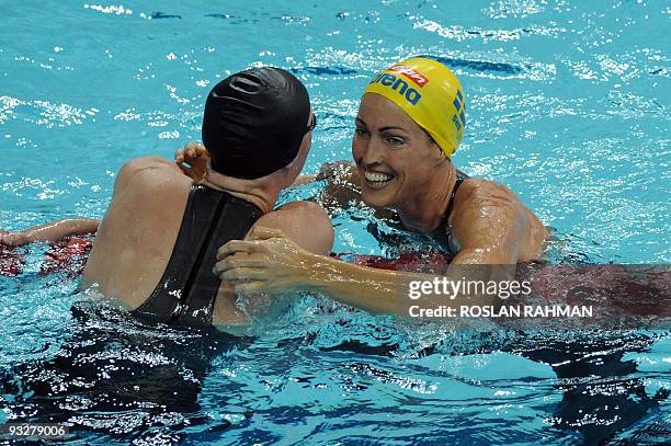 Sweden's Therese Alshammar embraces Dekker Inge of the Netherlands after the women's 50m freestyle event during the Fina/Arena Swimming World Cup...