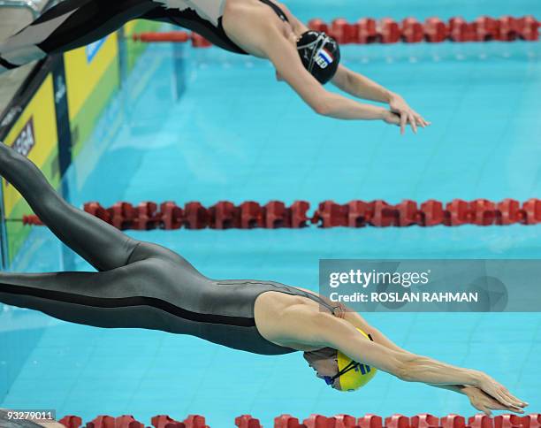 Sweden's Therese Alshammar dives in at the start of the women's 50m freestyle during the Fina/Arena Swimming World Cup 2009 in Singapore on November...