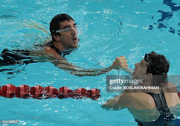 Australian Mathew Abood greets compatriot Mitchell Patterson after winning the men's 100m freestyle during the Fina/Arena Swimming World Cup 2009 in...