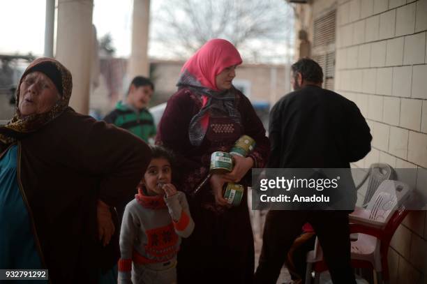 Civilians, who fled from their homes, are seen after receiving food aid from the Human Rights and Freedoms, Humanitarian Relief Foundation as Free...