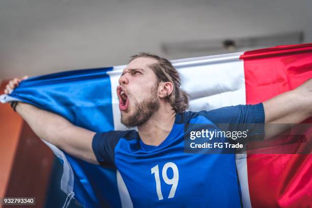french fan watching a soccer game - french culture stock pictures, royalty-free photos & images